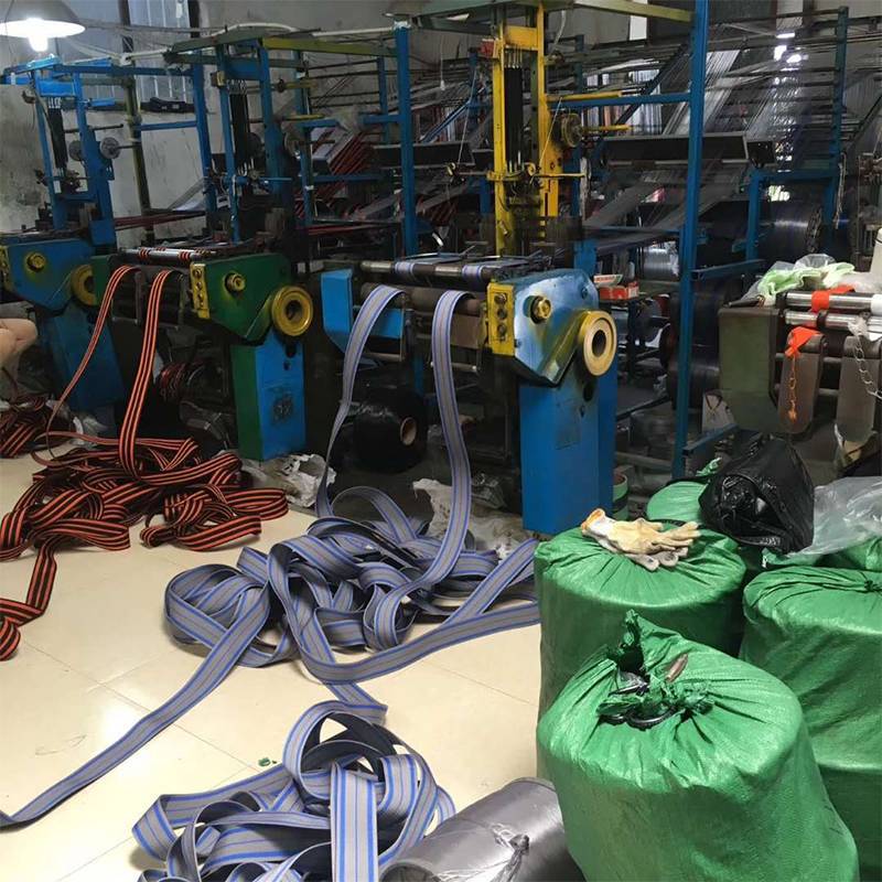 Machinery and woven straps on the production floor.
